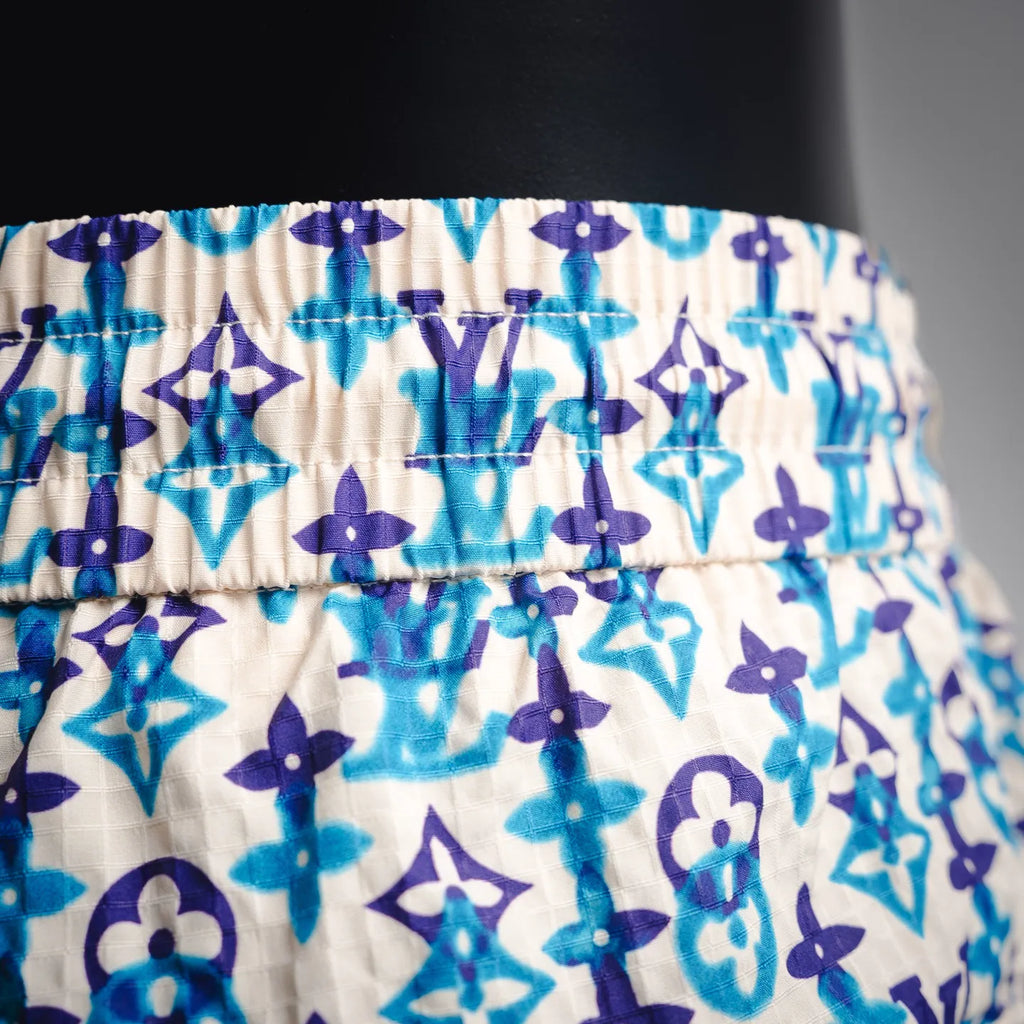 Elastic waistband on blue and navy patterned shorts with white base