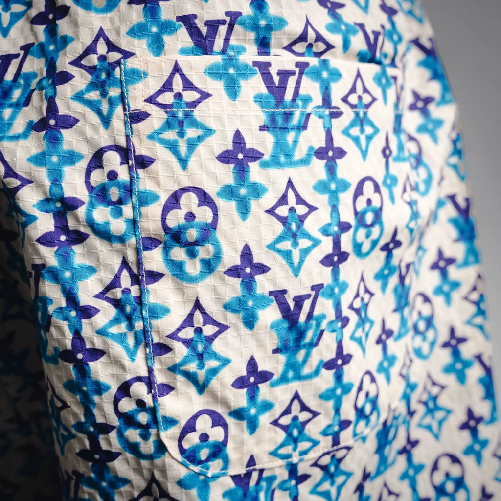 Blue and navy monogram shorts with visible seam and stitched construction