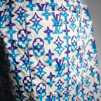 Blue and navy monogram shorts with visible seam and stitched construction