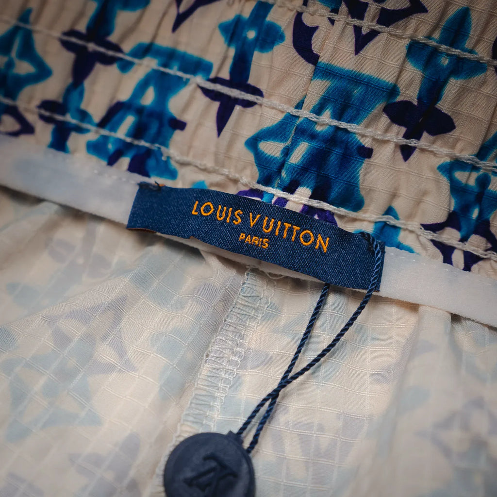 Louis Vuitton Paris label on blue and navy patterned shorts waistband