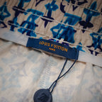 Louis Vuitton Paris label on blue and navy patterned shorts waistband