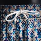 White drawstring with metal aglets on blue and navy monogram shorts