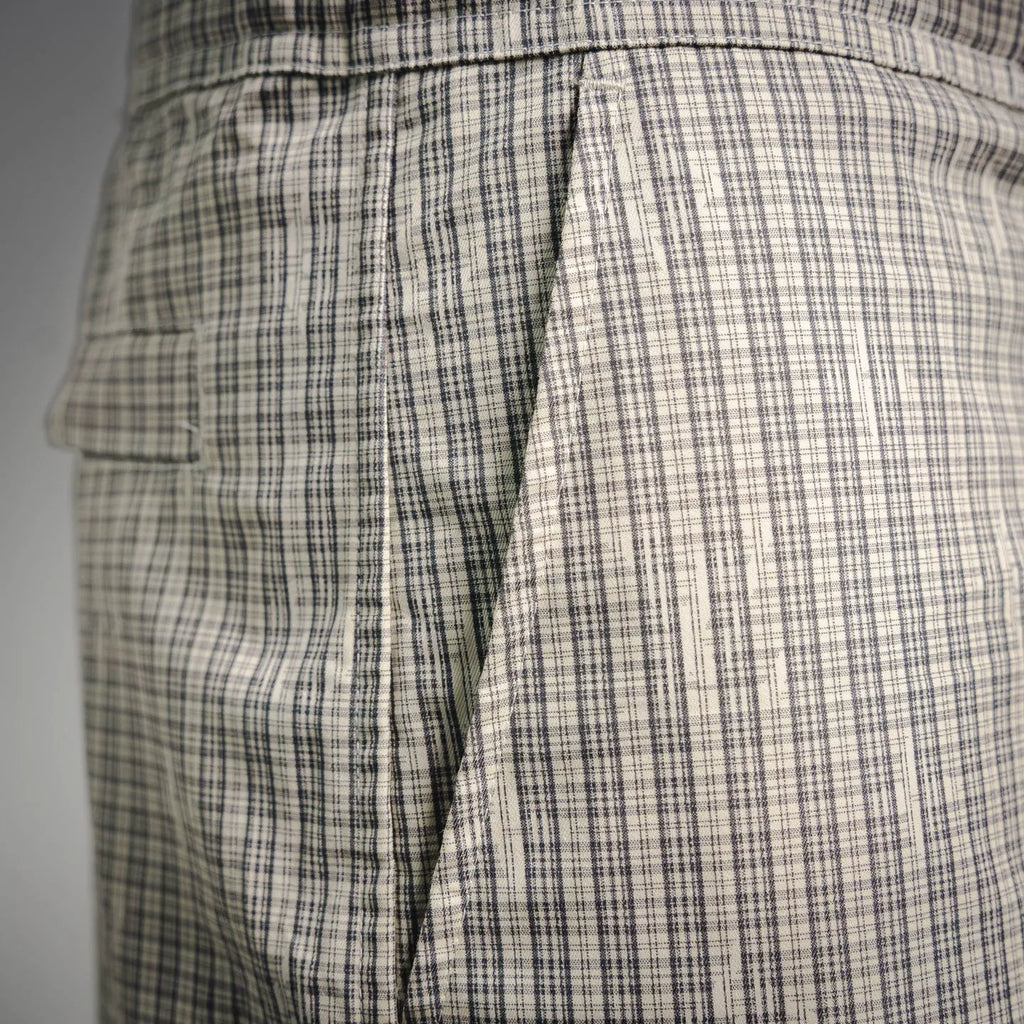 Plaid pants side view with pleats and cargo pocket panel stitching