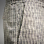 Plaid pants side view with pleats and cargo pocket panel stitching