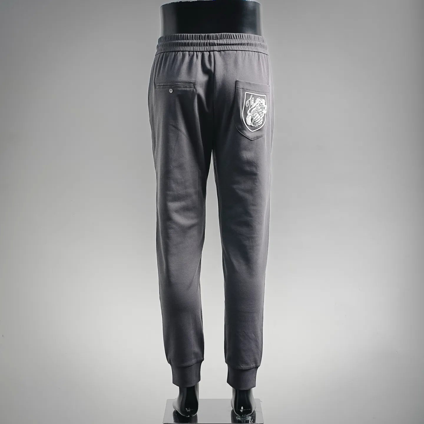 LV men's jogger pants back view with zip pocket and drawstring waist, dark gray