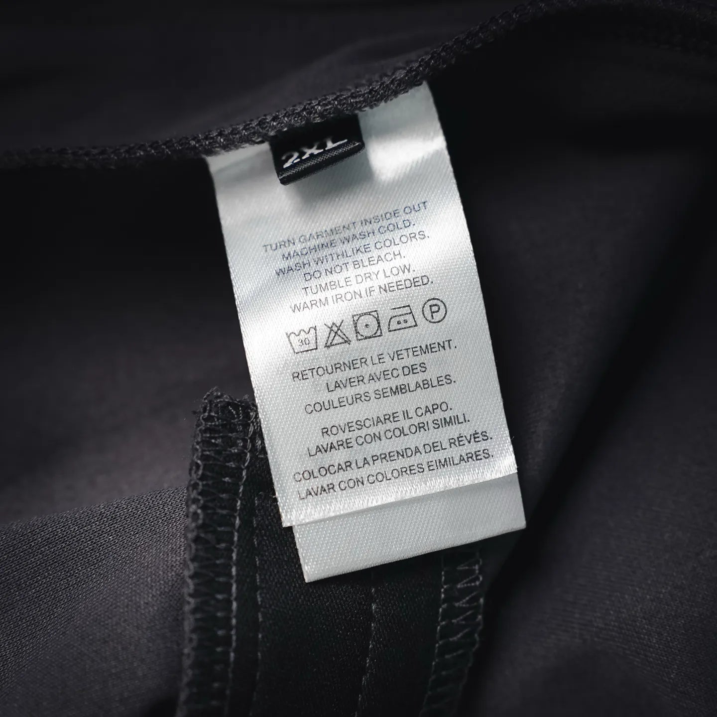 LV pants care and size label showing 2XL on inner seam, dark fabric
