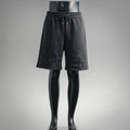 Black drawstring shorts with elastic waistband and LV-style logo embroidery