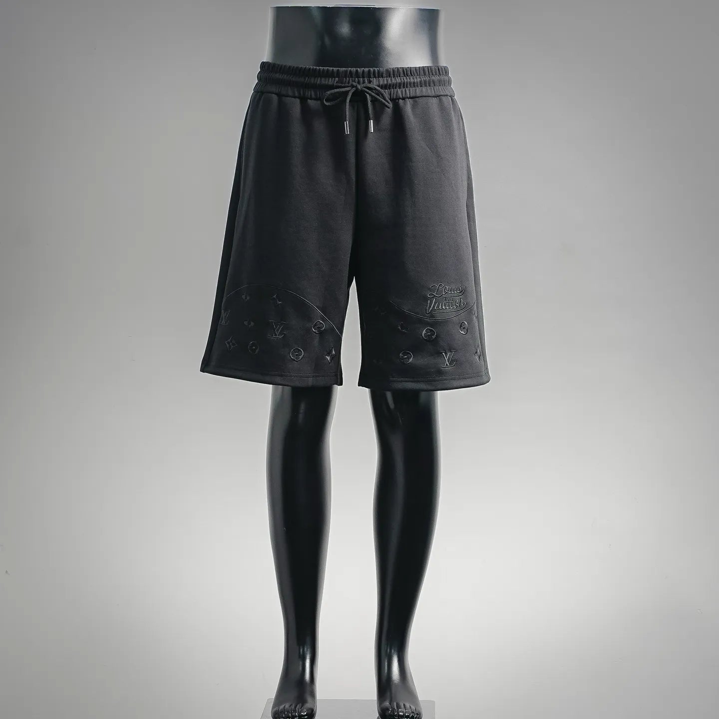 Black drawstring shorts with elastic waistband and LV-style logo embroidery