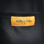 Black shorts with orange inner label reading 'LOUIS VUITTON'