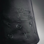 Black shorts with 'Louis Vuitton' script and small LV monogram emblems