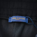 Black shorts inner tag reading 'LOUIS VUITTON PARIS'