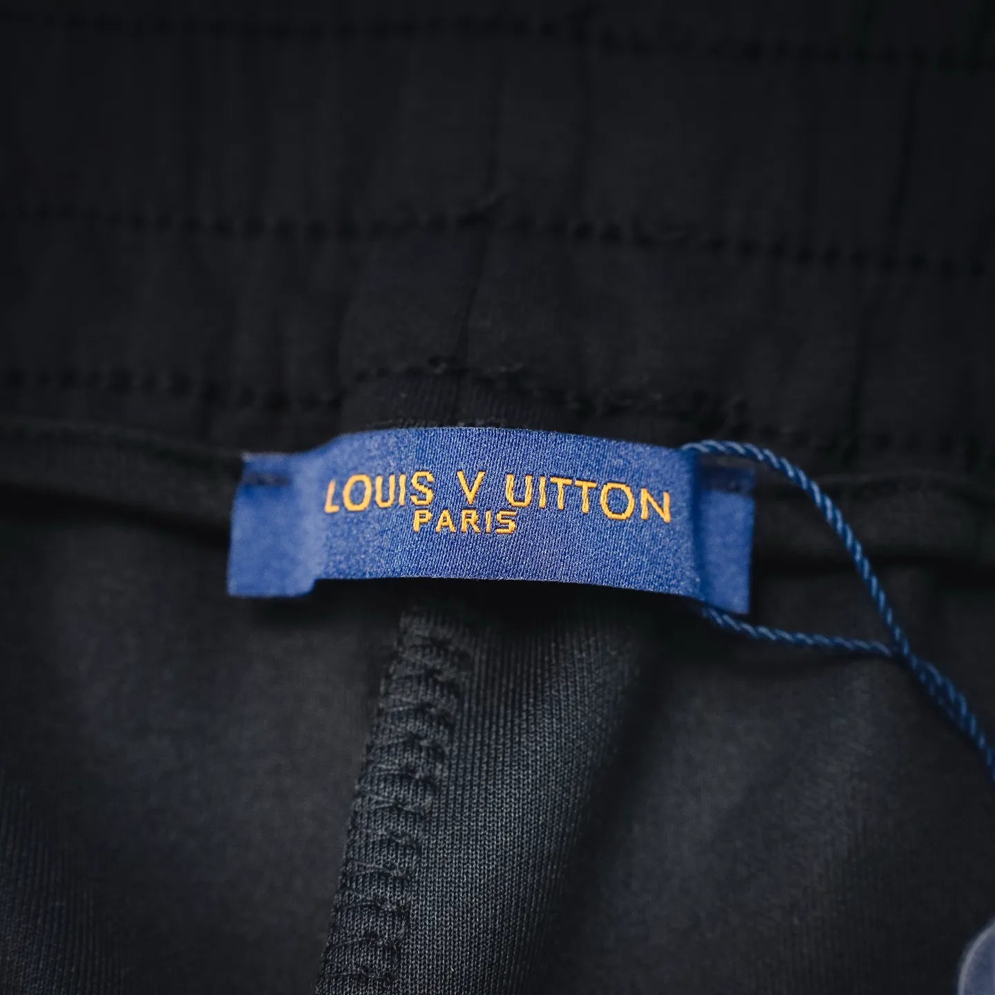 Black shorts inner tag reading 'LOUIS VUITTON PARIS'