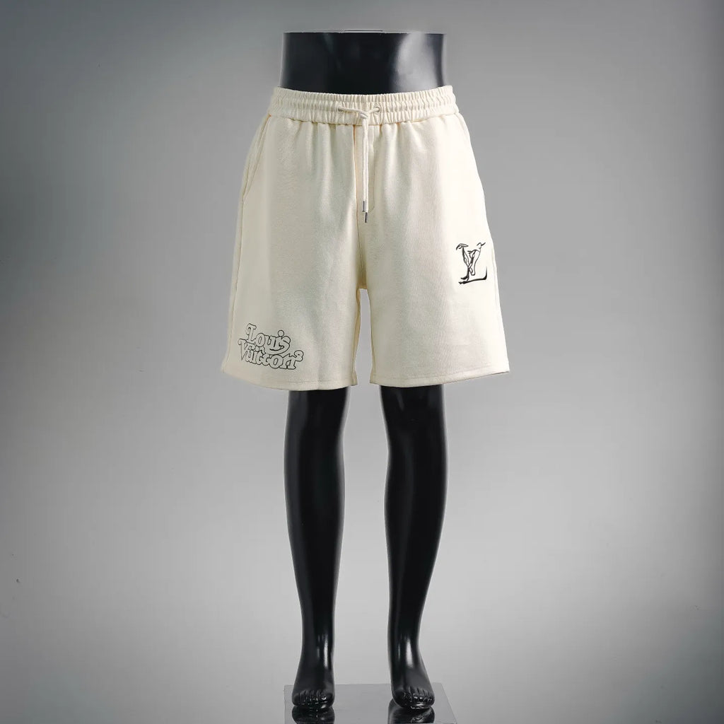 Cream elastic-waist shorts with drawstring, side pockets, and small logo print