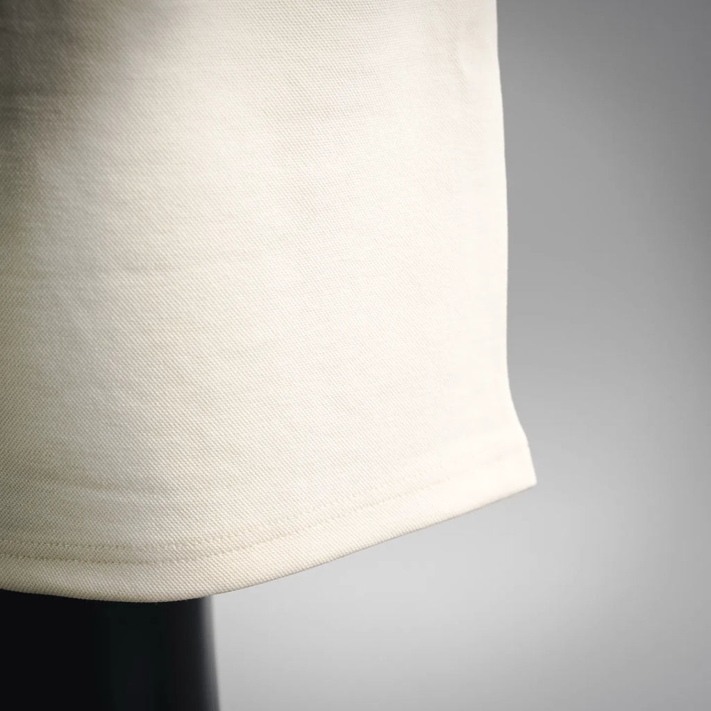 Cream shorts hem with smooth fabric and subtle side seam stitching