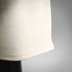 Cream shorts hem with smooth fabric and subtle side seam stitching