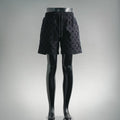 Black patterned shorts with elastic waistband and drawstring