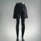 Black patterned shorts with elastic waistband and drawstring