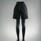 Black patterned shorts on mannequin legs, elastic waist and relaxed fit