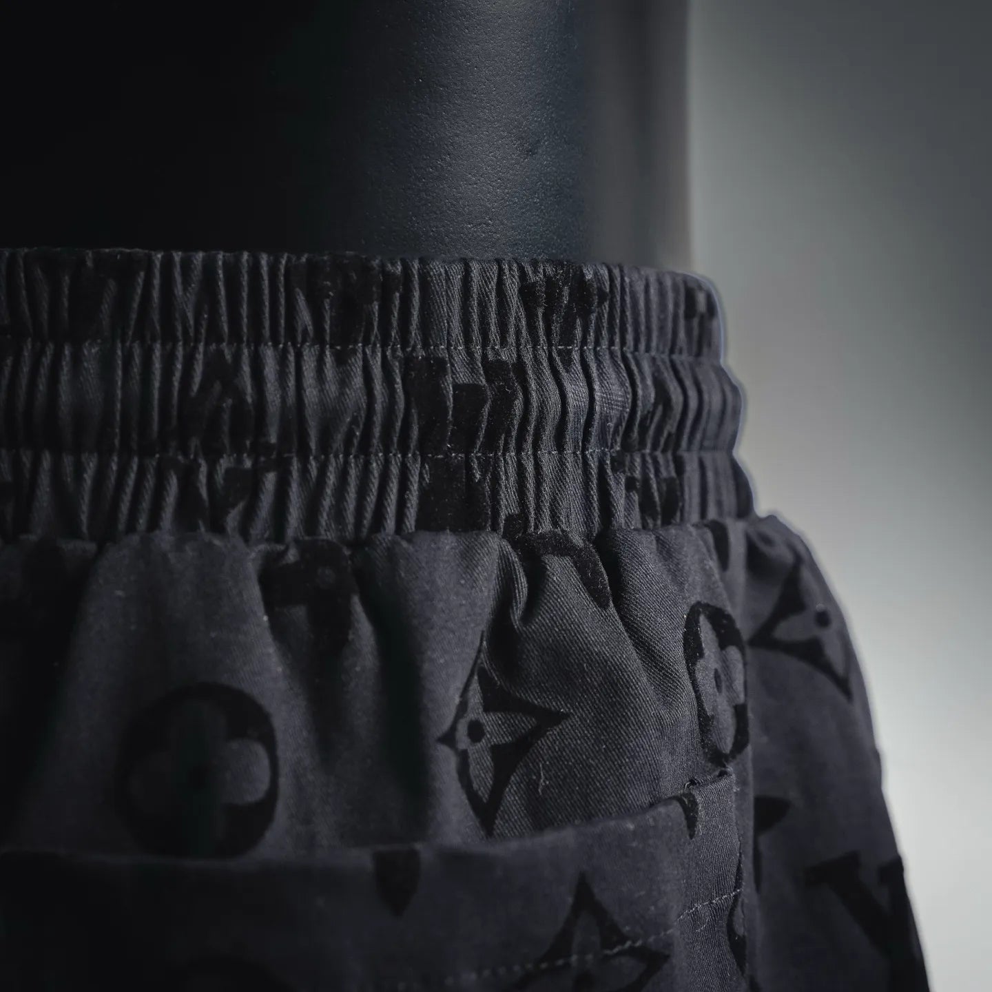 Elastic waistband and drawstring on black patterned shorts