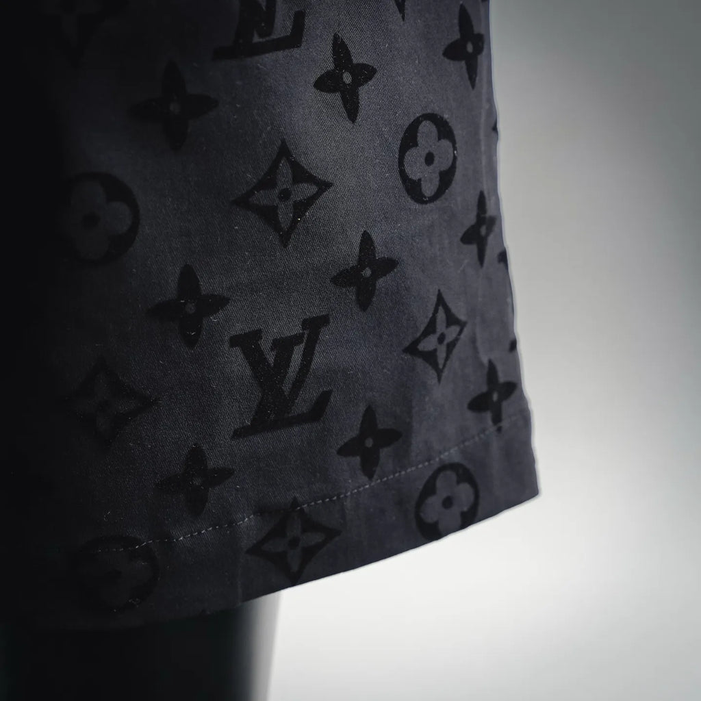 Black patterned shorts hem detail with visible side seam