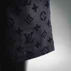 Black patterned shorts hem detail with visible side seam