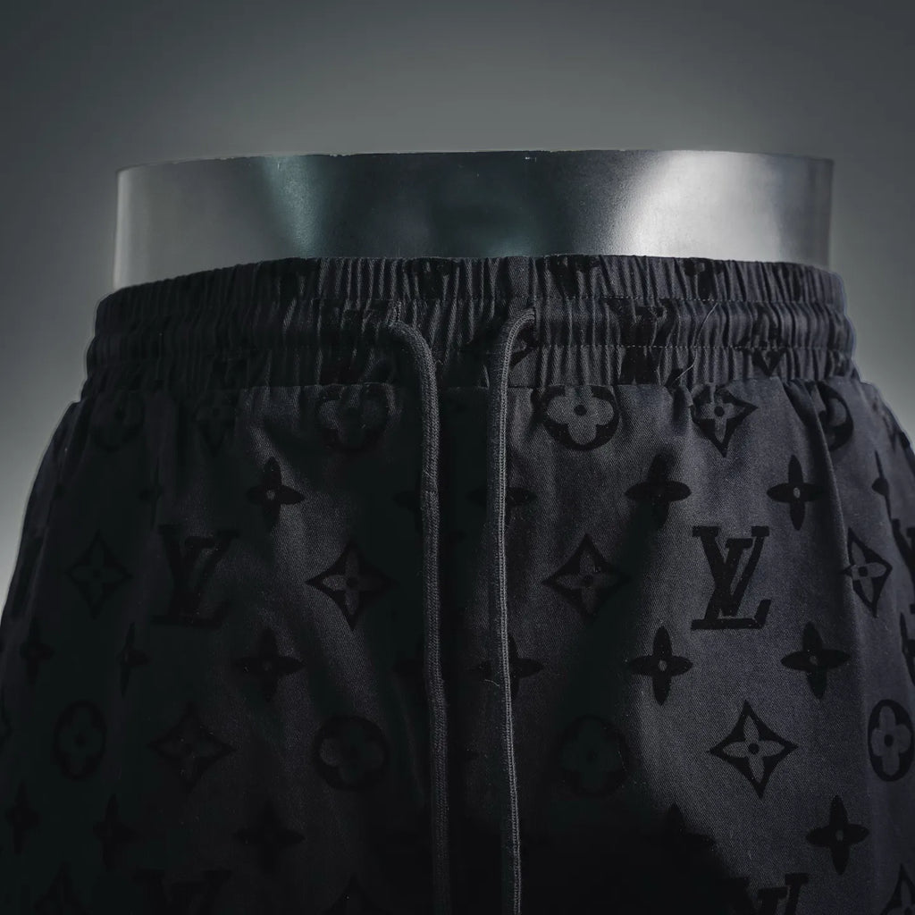 Front view of black monogram shorts with drawstring and elastic waist