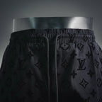 Front view of black monogram shorts with drawstring and elastic waist