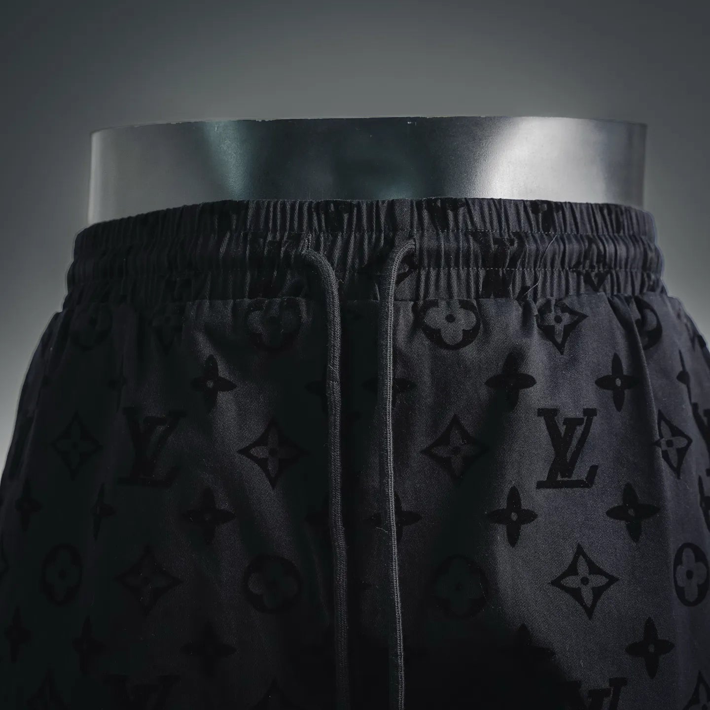 Front view of black monogram shorts with drawstring and elastic waist