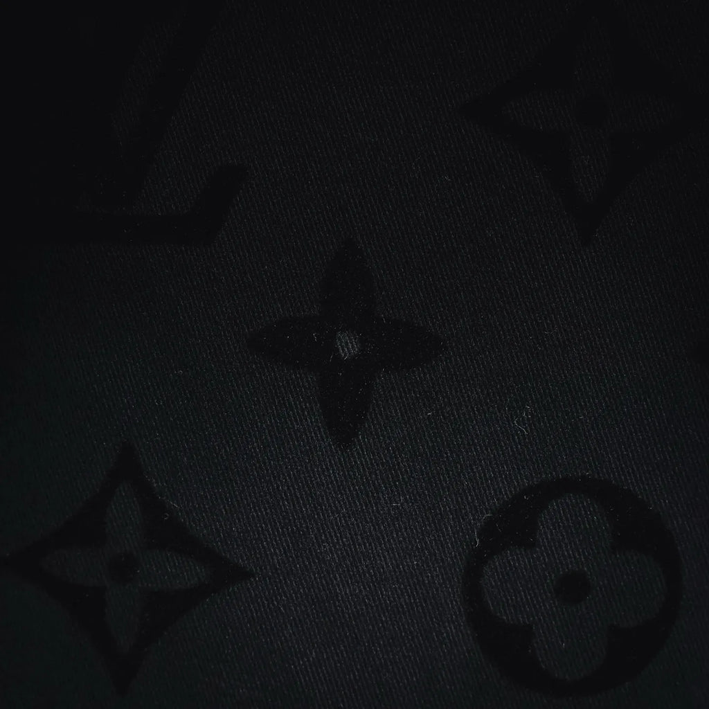 Black fabric close-up with repeating star motifs