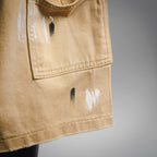 Beige LV shorts fabric close-up with distressed marks near the pocket