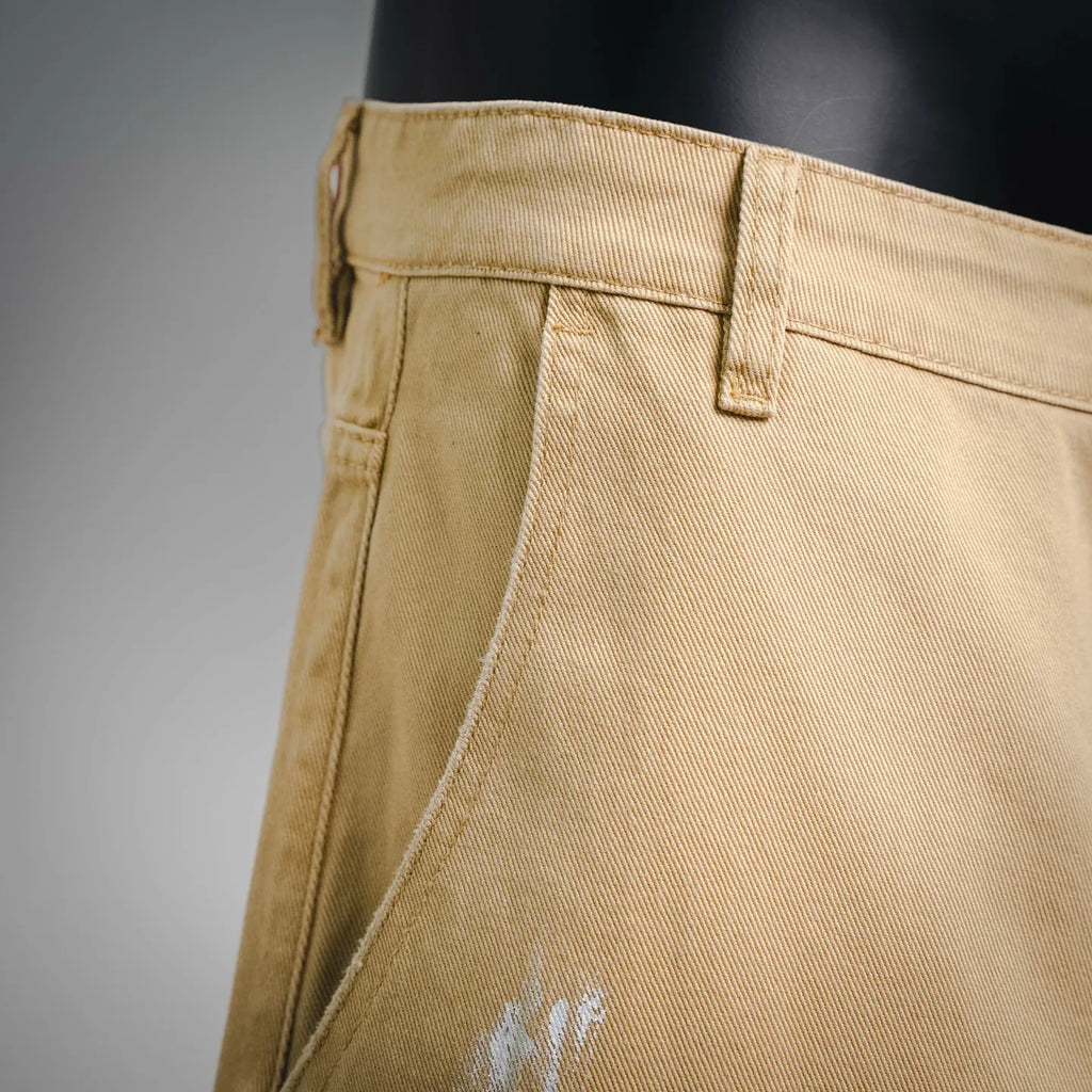Beige LV shorts front close-up with belt loops and stitched fly