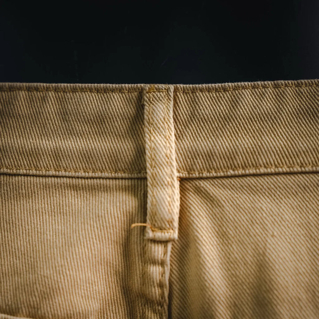 Beige LV shorts back waistband close-up with center seam and belt loop