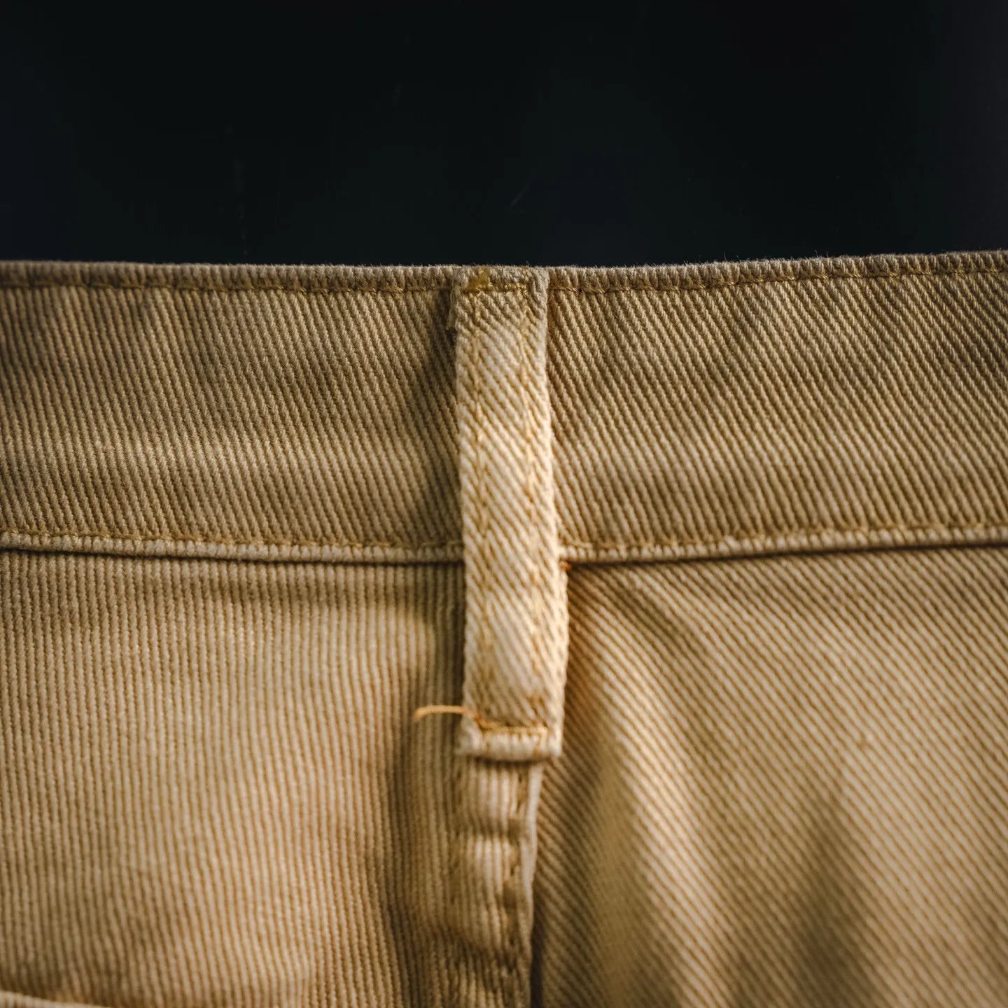 Beige LV shorts back waistband close-up with center seam and belt loop