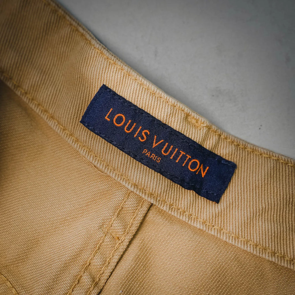 Beige LV shorts inner label with "LOUIS VUITTON" text