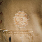 Beige LV shorts close-up with white graphic detailing on fabric