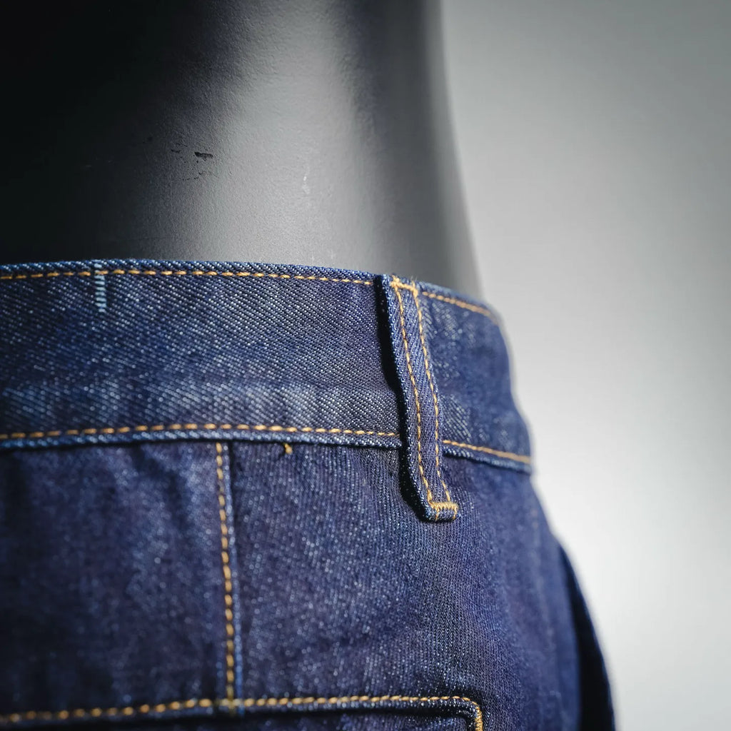 LV dark blue denim shorts side seam and pocket close-up with yellow stitching
