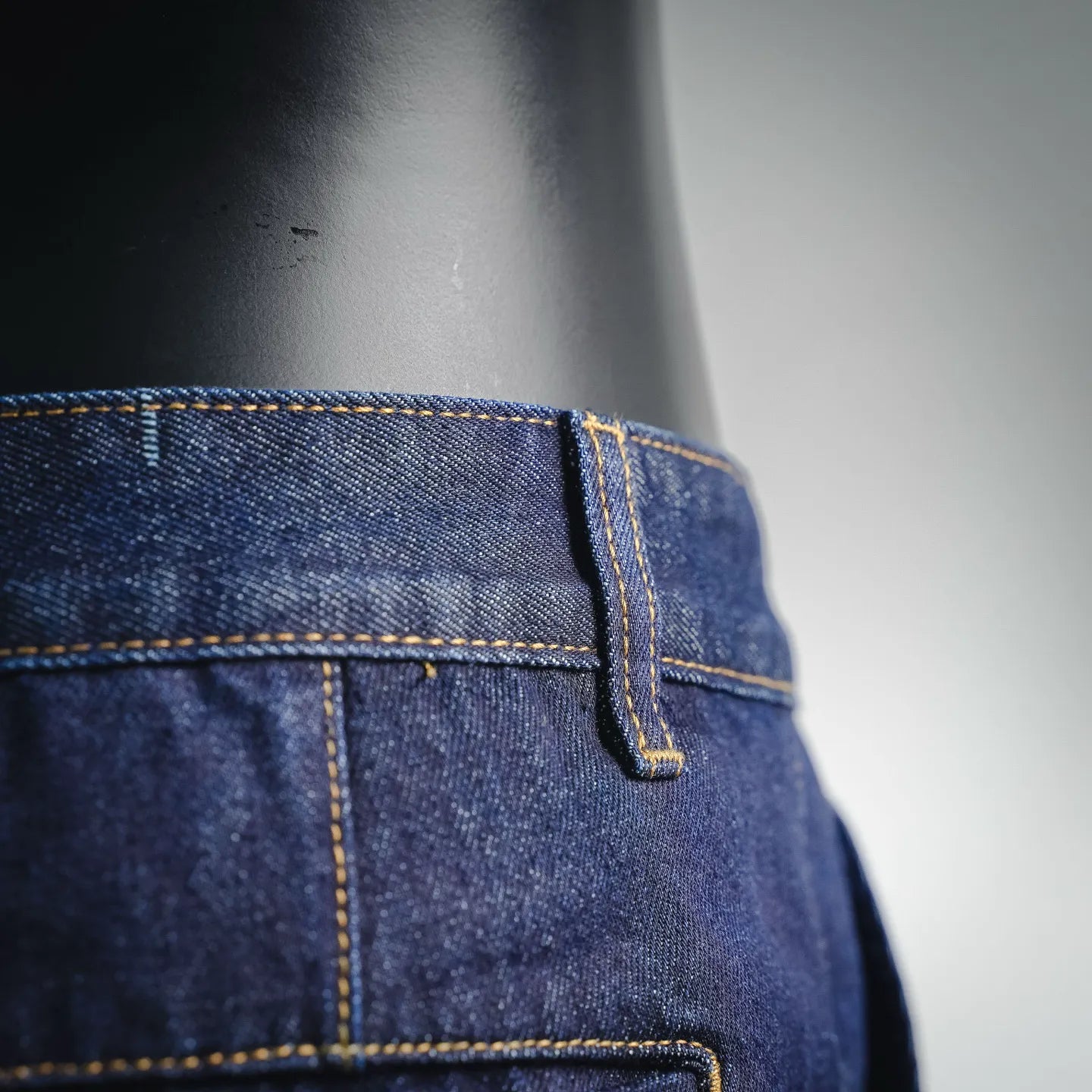 LV dark blue denim shorts side seam and pocket close-up with yellow stitching