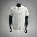 Off-white knit short-sleeve polo with buttonless half-zip and embroidered bear logo