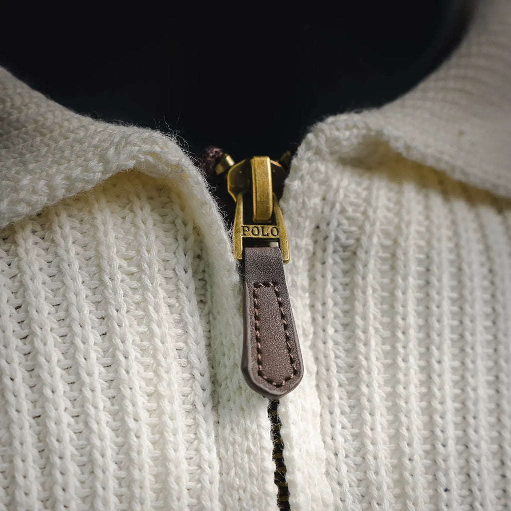 Half-zip with brown leather pull tab on off-white knit polo