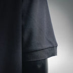 Dark navy polo shirt hem and sleeve cuff close-up with ribbed trim