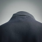 Dark navy polo shirt shoulder and collar seam close-up with ribbed neckline