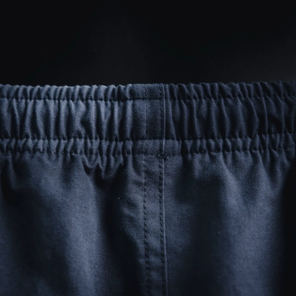 Navy elastic waistband and stitched center seam on Prada pants