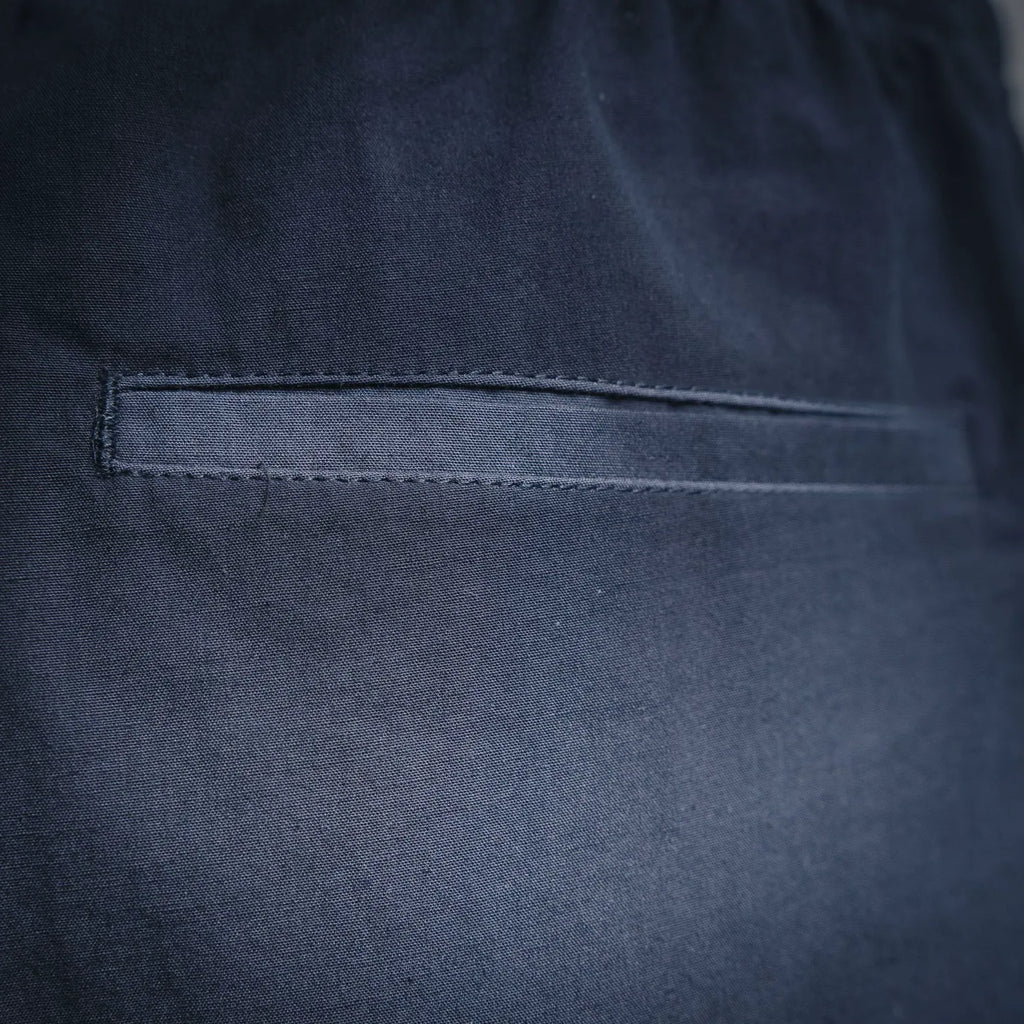 Navy Prada pants with side pocket and stitched hem detail