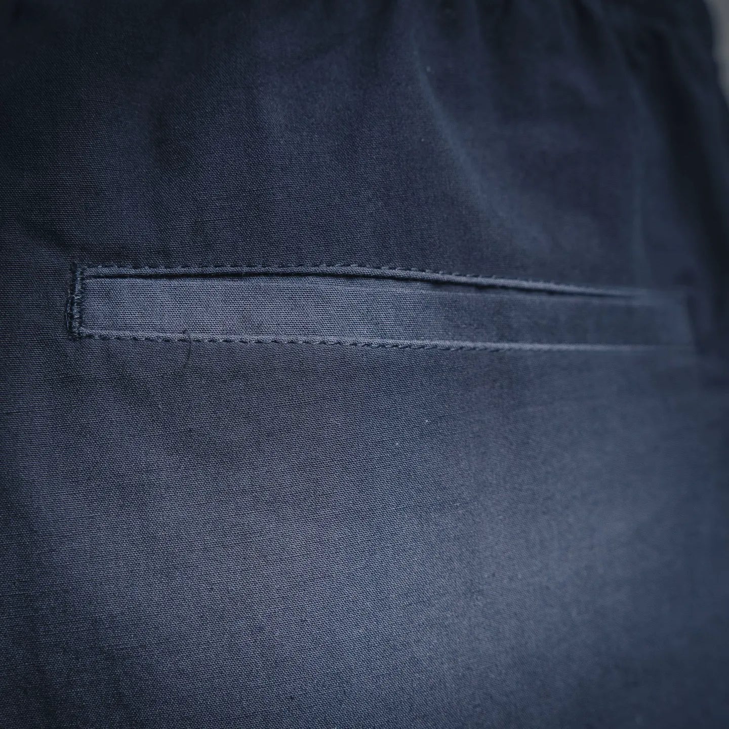 Navy Prada pants with side pocket and stitched hem detail