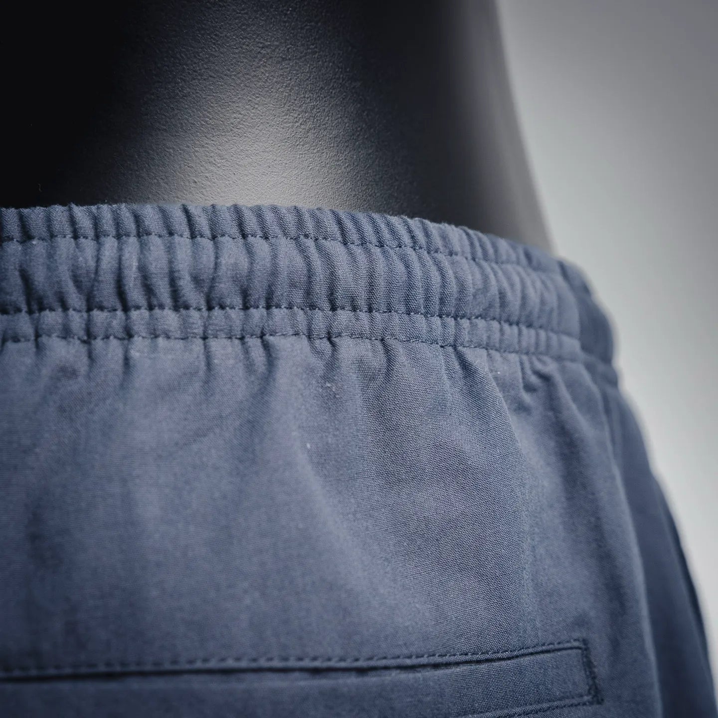 Navy Prada pants waistband with elastic ruching and stitched pocket opening