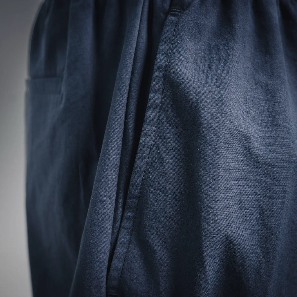 Navy Prada pants with side pleat and vertical seam detail