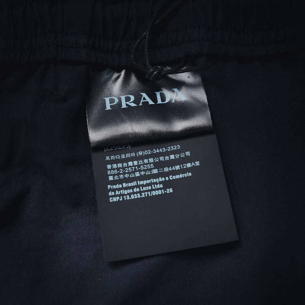 Prada fabric care tag on navy pants waistband