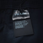 Prada fabric care tag on navy pants waistband