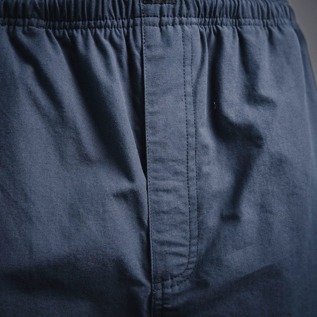 Navy Prada pants with front fly seam and elastic waistband stitching