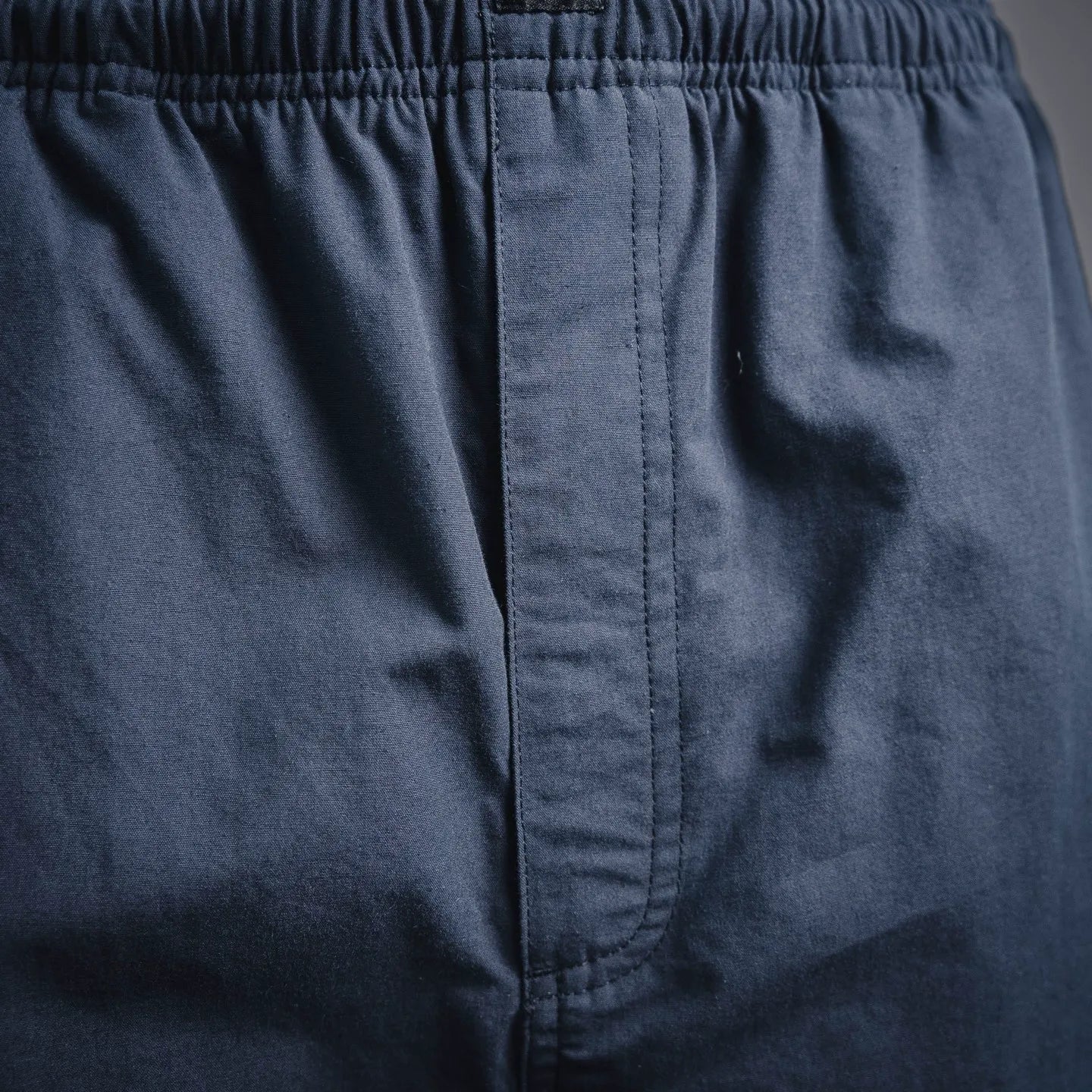 Navy Prada pants with front fly seam and elastic waistband stitching